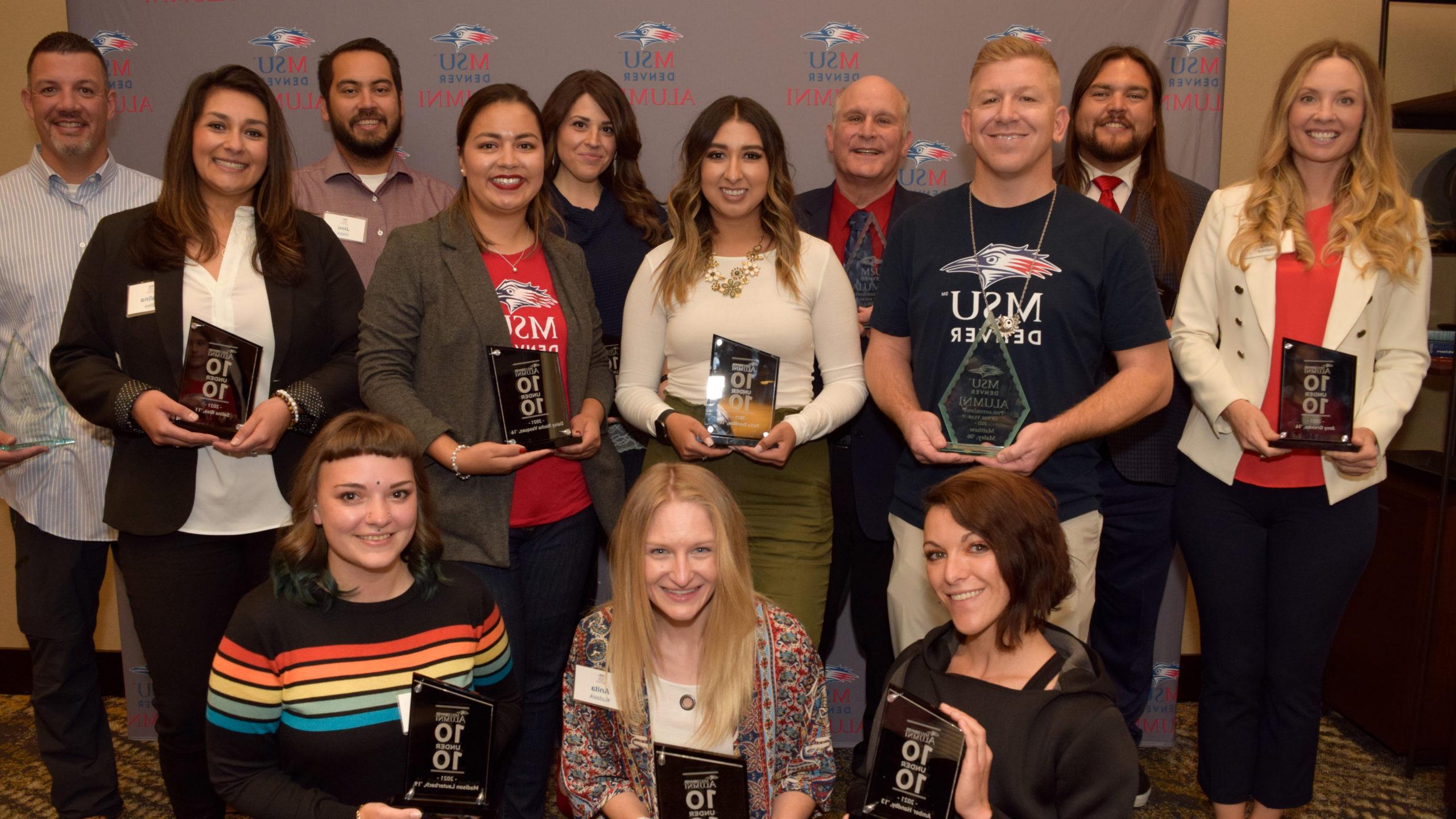 2021 10 under 10 award winners standing together with their awards in front of an MSU Denver backdrop.